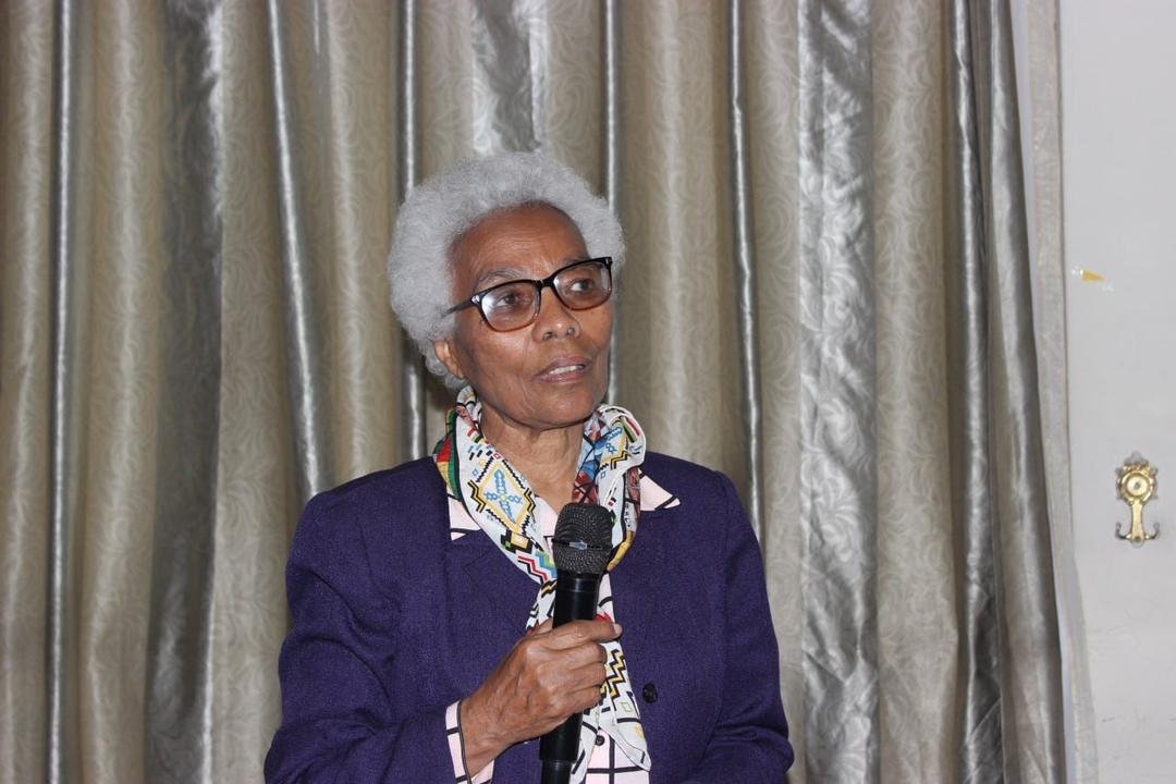 A speaker addressing guests at the Grand Opening